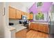 Spacious kitchen with stainless steel appliances, light wood cabinetry, hardwood floors, and granite countertops at 102 Legacy Ln, Durham, NC 27713