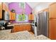 Well-lit kitchen with light wood cabinets, stainless steel appliances, granite counters, and hardwood floors at 102 Legacy Ln, Durham, NC 27713