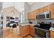 Kitchen with stainless steel appliances, wood cabinets, granite counters, and hardwood floors at 102 Legacy Ln, Durham, NC 27713