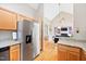 Open kitchen boasts stainless steel appliances, light wood cabinets, and granite countertops at 102 Legacy Ln, Durham, NC 27713