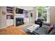 Cozy living room boasts a fireplace, built-in shelving, and a large window to the outdoors at 102 Legacy Ln, Durham, NC 27713
