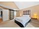 The neutral carpeted main bedroom has a barn door, an ensuite bathroom and stairs to another level at 102 Legacy Ln, Durham, NC 27713