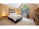 Bright main bedroom featuring a large arched window, neutral walls, and plush carpet at 102 Legacy Ln, Durham, NC 27713