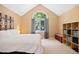 Bright main bedroom featuring a large arched window, neutral walls, and neutral carpet at 102 Legacy Ln, Durham, NC 27713