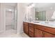 Primary bathroom with double sink vanity, ceramic tile flooring, and walk-in shower at 1049 Lakebrink Dr, Morrisville, NC 27560