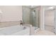 Bathroom with separate shower and tub, neutral colored tile, and vanity at 1049 Lakebrink Dr, Morrisville, NC 27560