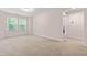 Spacious bedroom with neutral carpet, two windows, and ample natural light at 1049 Lakebrink Dr, Morrisville, NC 27560