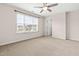 Carpeted bedroom featuring a large window and neutral paint; great for relaxing or studying at 1049 Lakebrink Dr, Morrisville, NC 27560