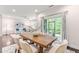Bright dining area featuring a wooden table, six chairs, and sliding glass doors to a screened porch at 1049 Lakebrink Dr, Morrisville, NC 27560