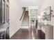 Inviting entryway with hardwood floors, staircase, decor table, and access to the living areas with bright natural light at 1049 Lakebrink Dr, Morrisville, NC 27560