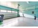 Garage features epoxy floors, painted walls, storage, and garage door opener at 1049 Lakebrink Dr, Morrisville, NC 27560