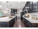 Stylish kitchen with stainless steel appliances, dark cabinets, white countertops, and ample storage space with a gas range at 1049 Lakebrink Dr, Morrisville, NC 27560