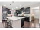Spacious kitchen with a large island, stainless steel appliances, dark cabinets, ample counter space, and bar stool seating at 1049 Lakebrink Dr, Morrisville, NC 27560