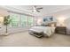 Inviting main bedroom with tray ceiling, bench seat, and three large windows providing natural light at 1049 Lakebrink Dr, Morrisville, NC 27560