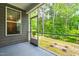 Screened porch overlooks backyard and showcases views of the trees at 1049 Lakebrink Dr, Morrisville, NC 27560
