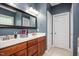 Bathroom featuring double vanity with wood cabinets and large framed mirror with modern lighting at 110 Lexington Ave, Zebulon, NC 27597