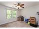Spacious, carpeted bedroom featuring natural light with a large window overlooking the backyard at 110 Lexington Ave, Zebulon, NC 27597
