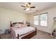 Bright bedroom with a ceiling fan and large window offering natural light at 110 Lexington Ave, Zebulon, NC 27597