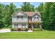 Charming two-story home with manicured lawn and landscaping at 110 Lexington Ave, Zebulon, NC 27597