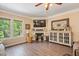 Bright living room with fireplace, hardwood floors, and ample natural light at 110 Lexington Ave, Zebulon, NC 27597