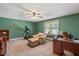 Versatile living room with a comfortable chair, a treadmill, a ceiling fan, and a desk at 110 Lexington Ave, Zebulon, NC 27597