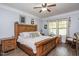 Bedroom with hardwood floors, a wood-framed bed, and two windows with natural light at 110 Lexington Ave, Zebulon, NC 27597
