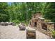 Stone outdoor fireplace for relaxing and entertaining in the backyard at 110 Lexington Ave, Zebulon, NC 27597