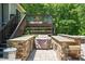 Outdoor kitchen area with built in bar for outdoor enjoyment at 110 Lexington Ave, Zebulon, NC 27597