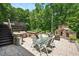 Stone patio with a built-in outdoor fireplace, ideal for entertaining and outdoor living at 110 Lexington Ave, Zebulon, NC 27597