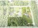 This aerial view shows a well-developed neighborhood with houses, roads, and dense tree coverage at 1105 Horseshoe Rd, Durham, NC 27703