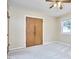 A bedroom with two windows, a ceiling fan, and double door closet at 1105 Horseshoe Rd, Durham, NC 27703