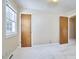 Light and airy bedroom with neutral walls, carpet, and ample closet space at 1105 Horseshoe Rd, Durham, NC 27703