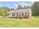 Well-kept brick house with a green lawn and inviting curb appeal at 1105 Horseshoe Rd, Durham, NC 27703