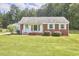 Charming brick home with a well-maintained lawn and mature trees at 1105 Horseshoe Rd, Durham, NC 27703