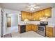 Open kitchen with wooden cabinets, stainless steel appliances, and a ceiling fan at 1105 Horseshoe Rd, Durham, NC 27703