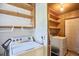 A well-equipped laundry area, complete with shelving and a washer and dryer at 1105 Horseshoe Rd, Durham, NC 27703