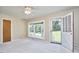 Bright living room with large windows and neutral carpet flooring at 1105 Horseshoe Rd, Durham, NC 27703