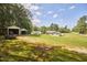 Scenic property view features expansive lawns, diverse structures, and a tree-lined perimeter for privacy at 1105 Horseshoe Rd, Durham, NC 27703