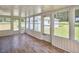 Sunroom with wood flooring and large windows with backyard views at 1105 Horseshoe Rd, Durham, NC 27703