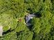Aerial view of a home surrounded by lush green trees, offering seclusion and a harmonious connection with nature at 11425 Horsemans Trl, Raleigh, NC 27613