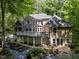 Spacious back exterior featuring a multilevel deck, hot tub, manicured yard, and multiple access points at 11425 Horsemans Trl, Raleigh, NC 27613