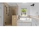 Bathroom with a tiled glass shower, soaking tub with jets, and a bright window view at 11425 Horsemans Trl, Raleigh, NC 27613