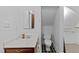 Cozy bathroom featuring classic vanity, toilet, and closet with black and white tile flooring at 11425 Horsemans Trl, Raleigh, NC 27613