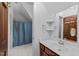 Bathroom featuring tiled shower with curtain, vanity, and mirror at 11425 Horsemans Trl, Raleigh, NC 27613
