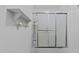 Bright bathroom showing glass door shower with silver trim and white shelving at 11425 Horsemans Trl, Raleigh, NC 27613