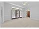 Bedroom featuring carpet flooring, three doors, and neutral colored walls at 11425 Horsemans Trl, Raleigh, NC 27613