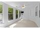 Bright carpeted bedroom featuring a ceiling fan and a three-window view at 11425 Horsemans Trl, Raleigh, NC 27613