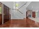 Grand entryway with stone fireplace and staircase leading to upper floors at 11425 Horsemans Trl, Raleigh, NC 27613