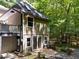 Back exterior showing access to multi-level deck, access to the home, and lush landscaping at 11425 Horsemans Trl, Raleigh, NC 27613
