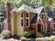 Rear view of an attractive brick home with a lush green backdrop at 11425 Horsemans Trl, Raleigh, NC 27613